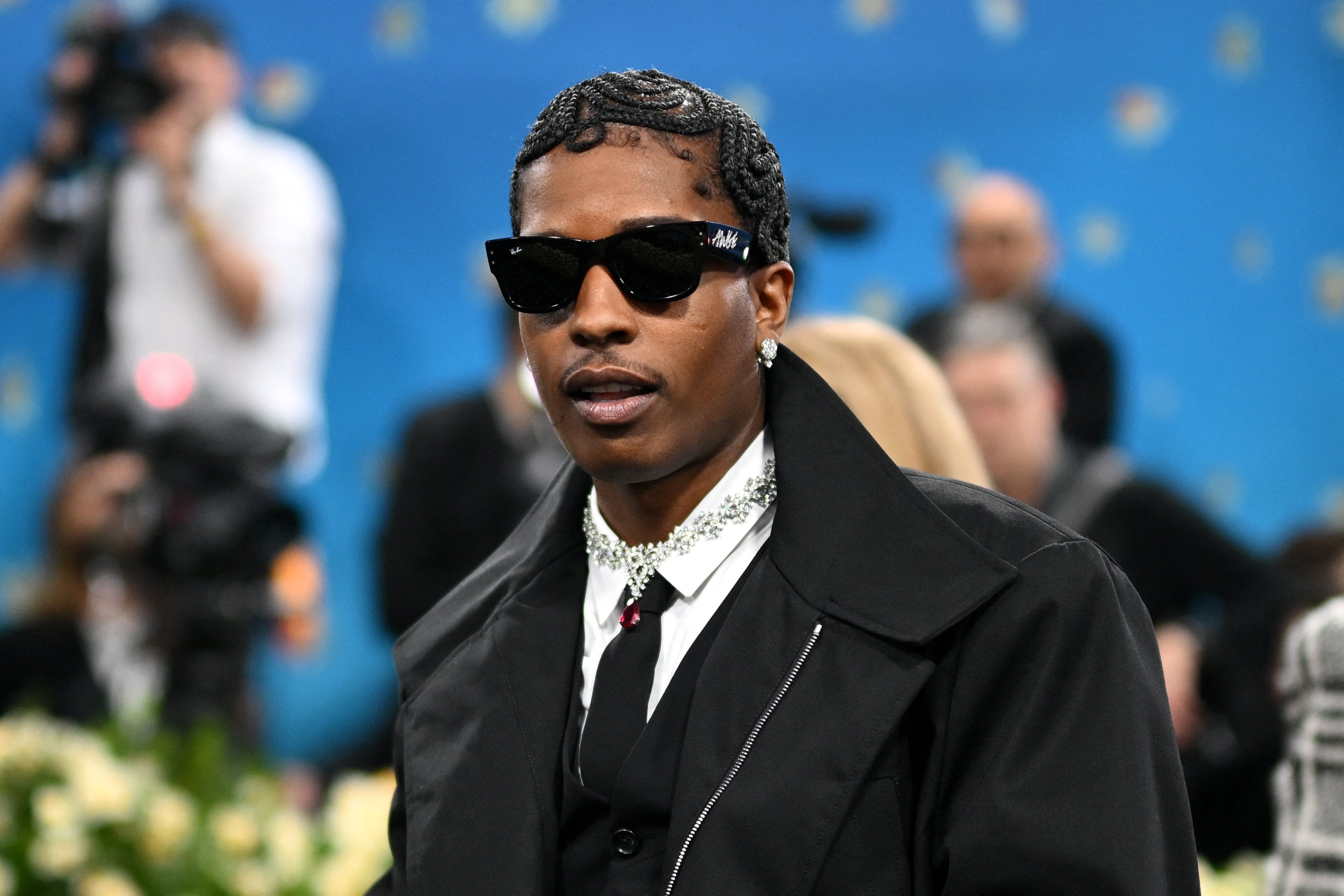 A$AP Rocky opted for the classic black suit and tie, paired with a matching black jacket and sunglasses