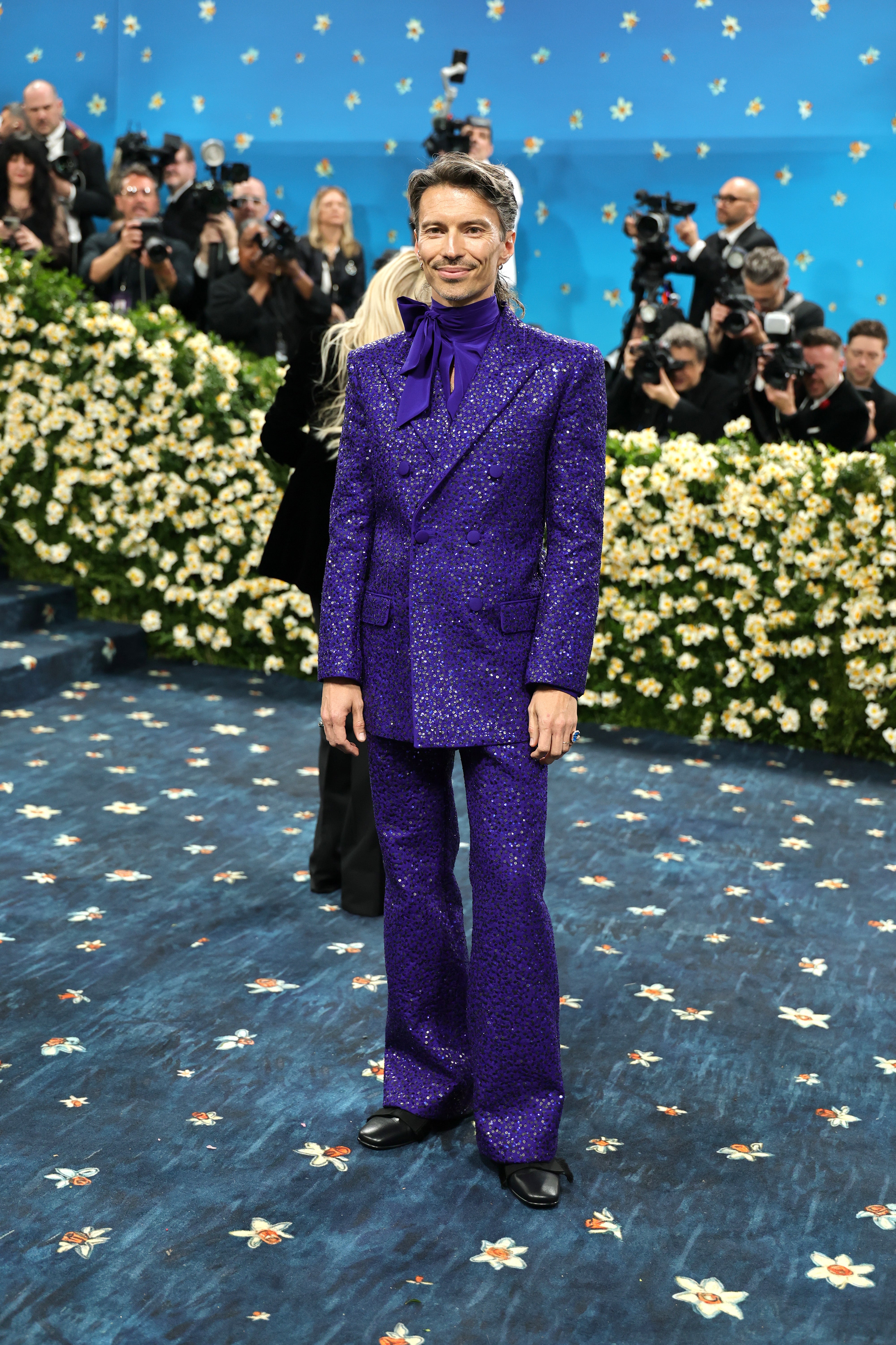 Raúl Domingo, husband of Met Gala co-chair Colman Domingo, wore a glitter purple tuxedo and a matching silk shirt with a bow by Valentino