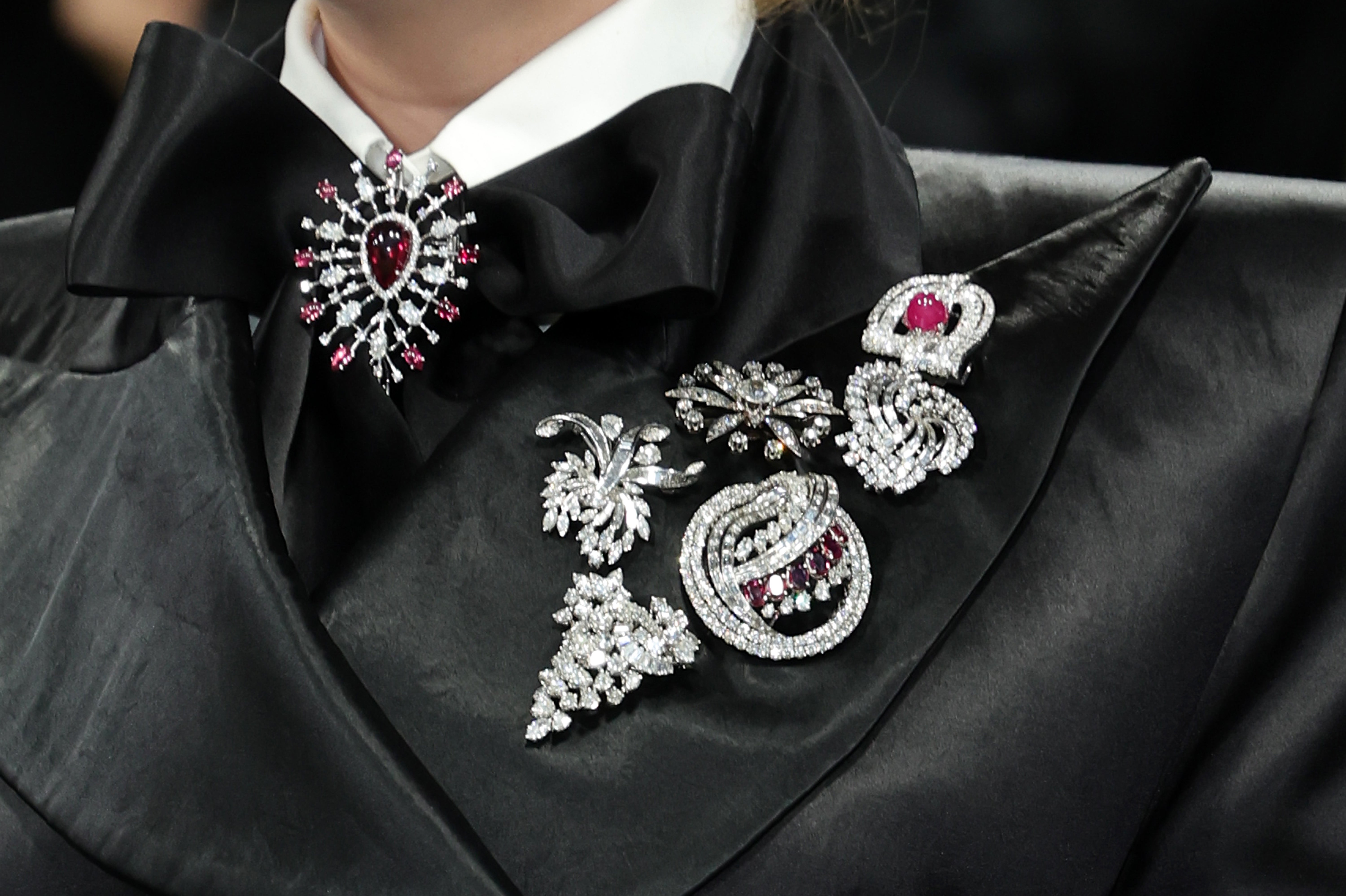 Snook had a series of silver brooches on the side of her jacket with another attached to the middle of the tie of her outfit