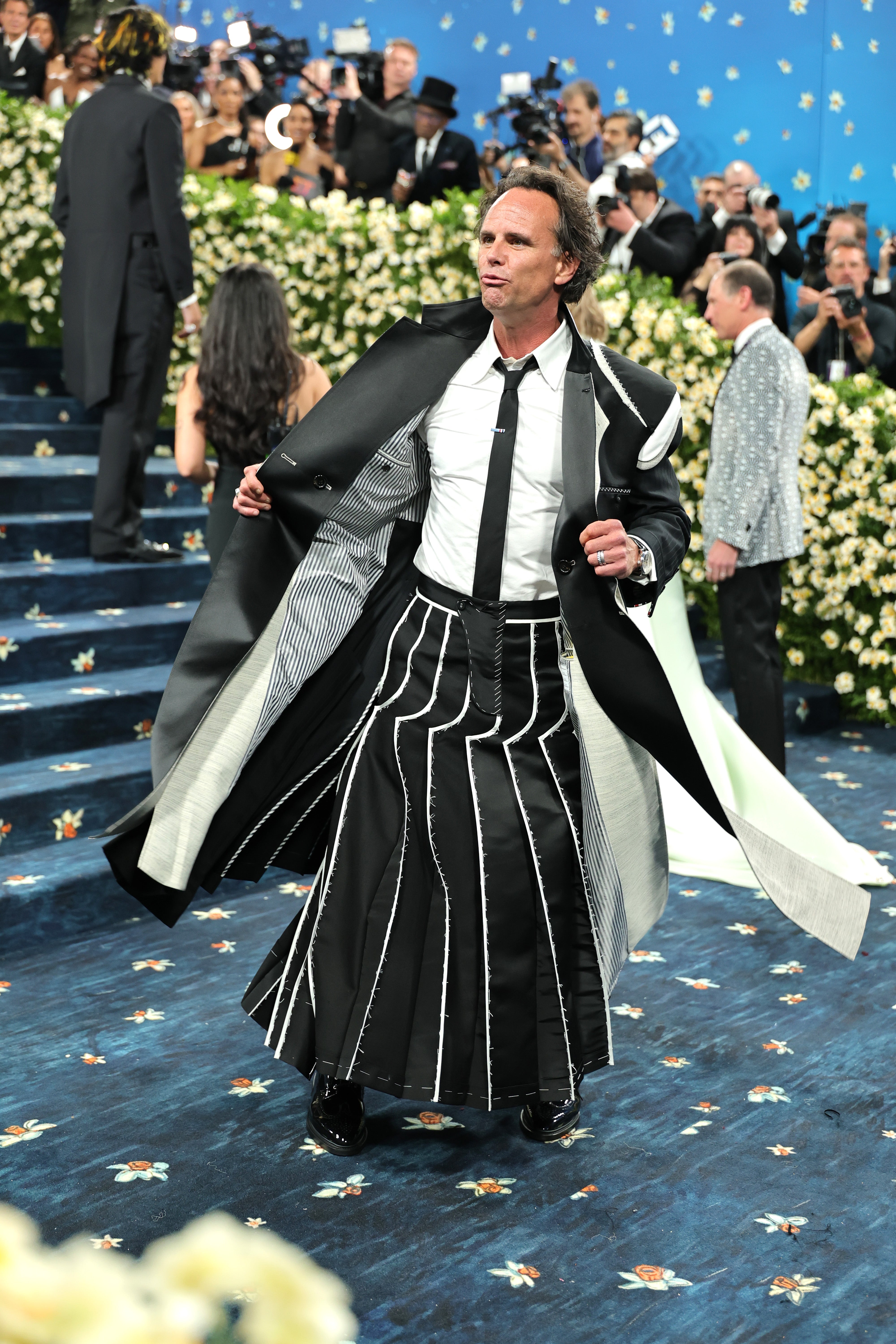 Walton Goggins, who starred in season three of ‘The White Lotus,’ wore a black skirt with white stripes and a matching, long jacket, designed by Thom Browne