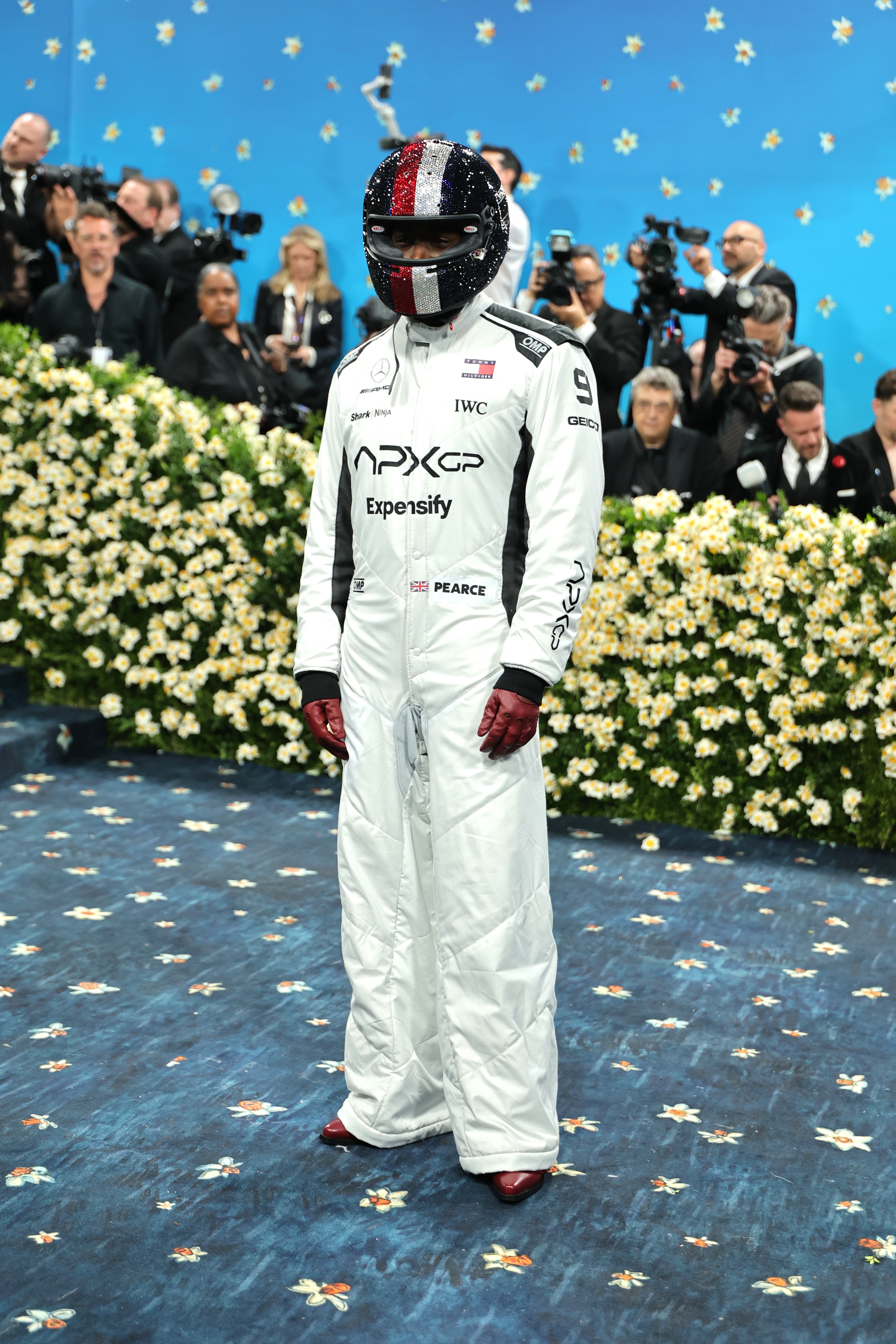 Damson Idris, who’s starring in the new ‘F1’ film, posed in a white racing suit and red leather gloves and a black bedazzled helmet